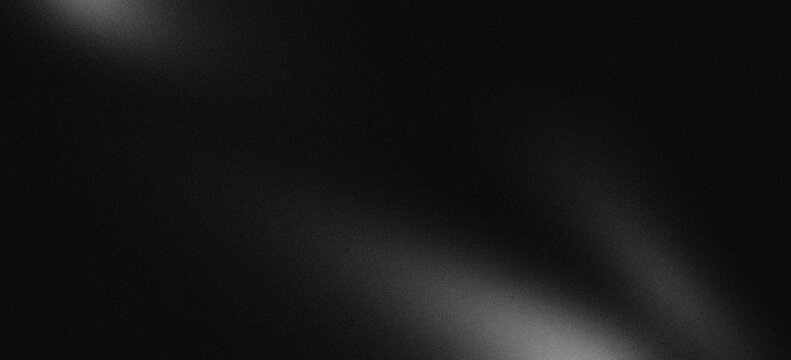 Monochrome abstract grey smooth gradation on black background with grainy noise texture.