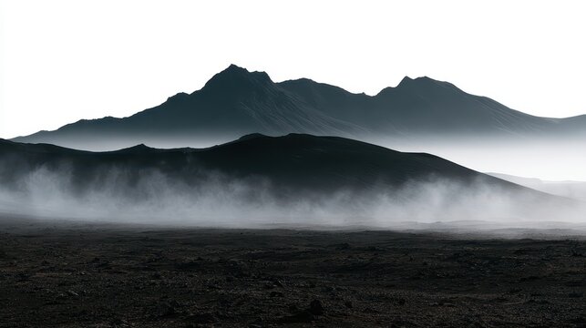 Dramatic volcanic landscape in iceland with mist and fog covering the dark rocky terrain and mountains in the background