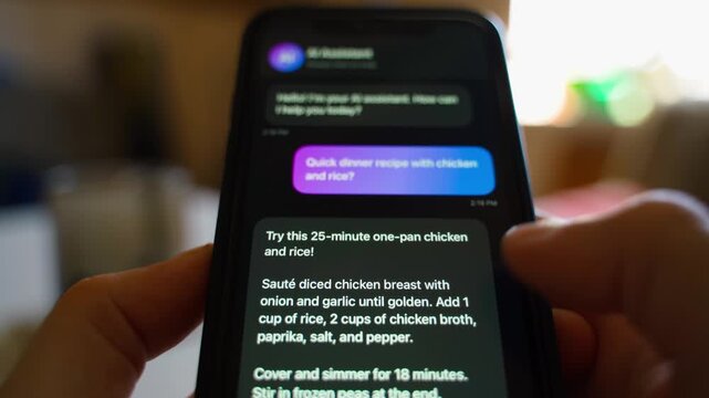 Hands holding smartphone with AI assistant chat asking for dinner recipe
