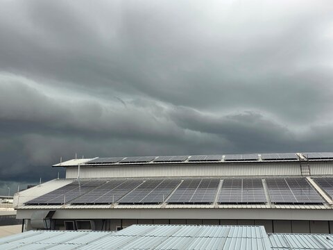 Rooftop Solar Panels Under Stormy Sky
