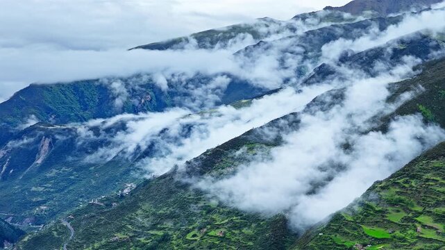 Aerial view of the summer landscape in Shuangqiao Valley Scenic Area of Mount Siguniang, Aba Prefecture, Sichuan, China, with mist-shrouded mountains