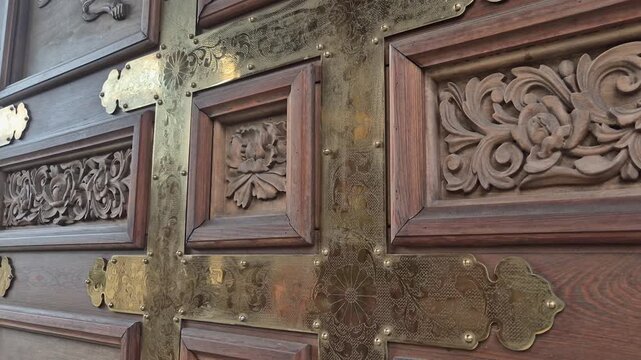 Close up of antique wooden door with brass details