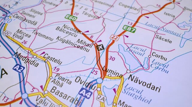 Gliding macro view over atlas map showing the road network leading to Constanta,Romania