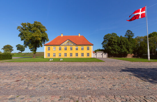 Historic Yellow Building with Danish Flag in Copenhagen Denmark