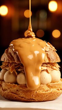 Gourmet Paris-Brest Pastry Featuring Crisp Choux Dough Filled with Silky Nut Cream and Topped with Cascading Caramel Drizzle