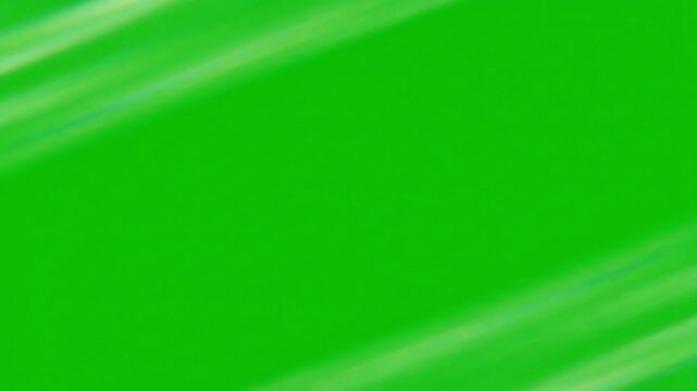 Vibrant emerald green silk fabric background featuring soft flowing waves of elegant textile motion in this smooth professional video footage animation creating a luxurious and serene atmosphere