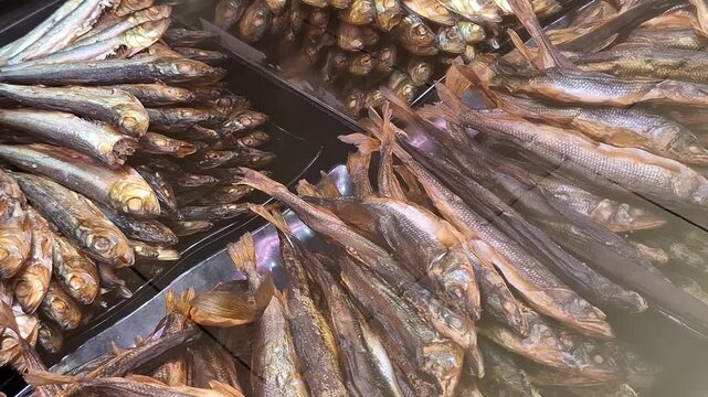 Smoked fish assortment on display at a seafood market counter. retail fish shop, savory food, gourmet snacks.