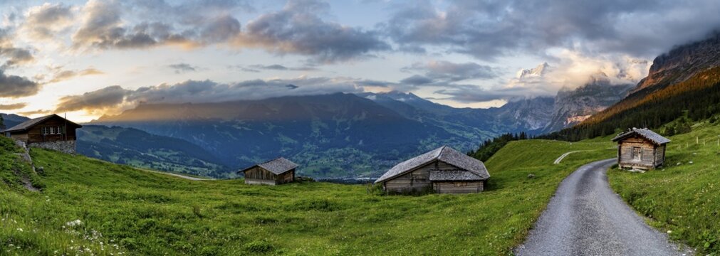 Road, alpine huts and alpine meadows, mountain landscape at sunset, summit of the Wetterhorn in the background, Alpiglen, Grindelwald, Bernese Oberland, Switzerland