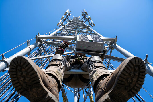 Telecommunications technician working on a cell tower