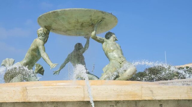 bronze triton figures support a wide fountain bowl close up sculptural detail valletta capital city landmark triton fountain valletta city gate bronze statue fountain malta landmark fountain
