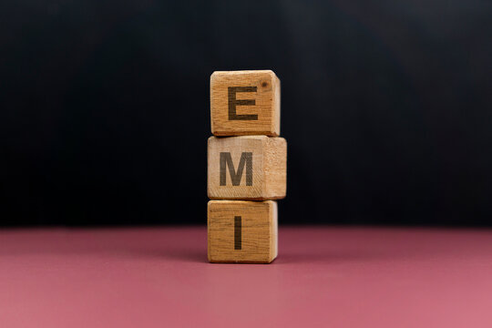 EMI word on a stack of wooden cubes. Financial Investment Concept