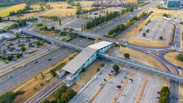 Aerial view of Assago Milanofiori Forum metro station, the southern terminus of Milan Metro Line M2, surrounded by roads and urban infrastructure.