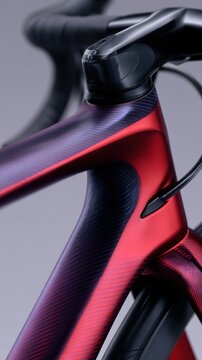 A close-up view of a sleek, modern bicycle frame showcasing a blend of deep red and purple colors