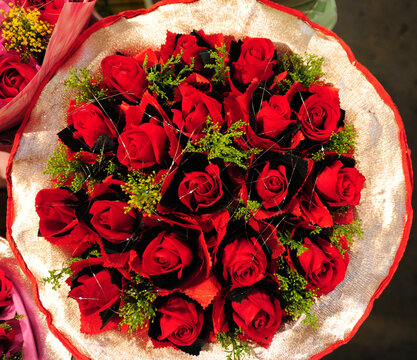 Red Rose Bouquet with Green Foliage and Fabric Wrap