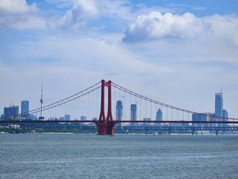 Red Suspension Bridge Connects City Across River