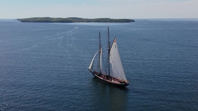 The majestic Bluenose glides gracefully through the sparkling waters of Halifax Bay beneath a beautiful, clear sky