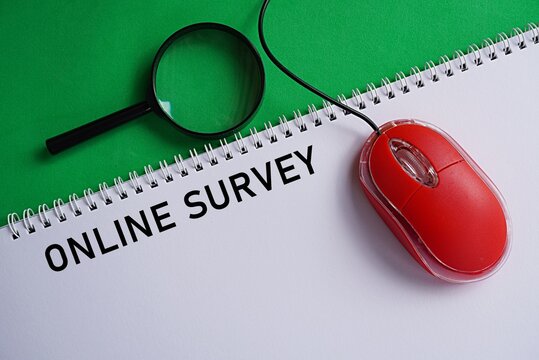 Mouse with printed note ONLINE SURVEY. World Internet Day concept. Global system connecting text, images and video using the internet. Collecting facts through online