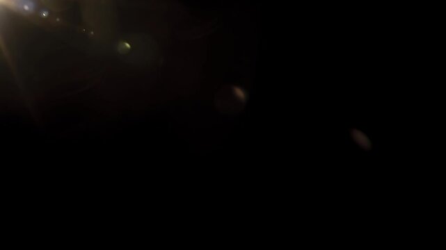 Real Cinematic Lens Flare Overlay on Black Background at 1000fps Slow Motion.