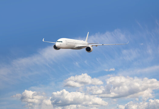 White passenger airplane flying in the sky amazing clouds in the background - Travel by air transport