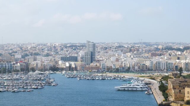 moored yachts fill ta xbiex marina msida and gzira skyline rising along the marsamxett harbour waterfront sliema skyline tigne point modern high rise waterfront apartments malta skyline