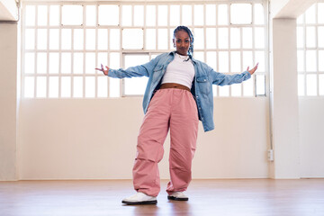 Hip-hop female dancer wearing colorful urban streetwear dancing
