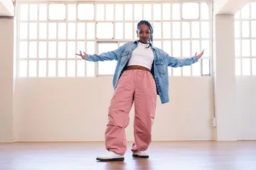 Fotobehang Dansers Hip-hop female dancer wearing colorful urban streetwear dancing  © oneinchpunch