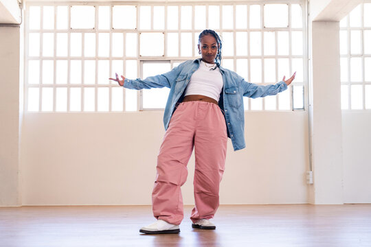 Hip-hop female dancer wearing colorful urban streetwear dancing