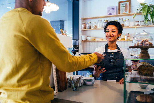 Barista working in a bar cafeteria