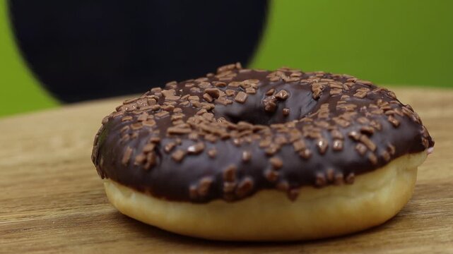 MVI chocolate glazed doughnut on wood.