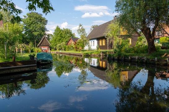 Lehde, Germany - July 16, 2026: Traditional Spreewald village houses along a peaceful canal with boats, lush gardens, and beautiful reflections
