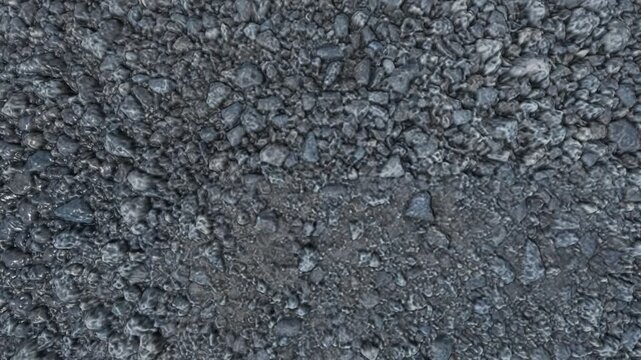 Overhead shot of wet, rough crushed grey stones and rocks. The jagged edges and moist surfaces create a highly detailed, rugged texture perfect for industrial, geological, or rugged terrain themes.