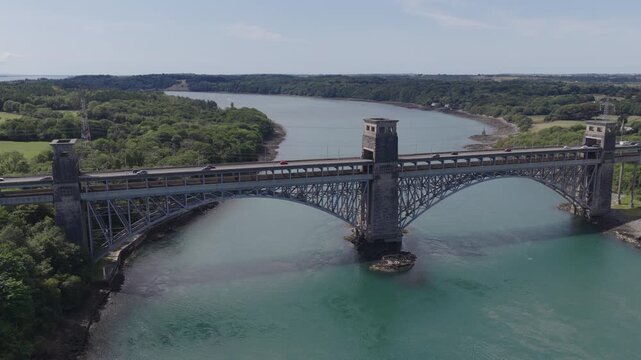 Establishing aerial view of the Britannia Bridge that crosses the Menai Strait between the Isle of Anglesey and mainland Wales, United Kingdom