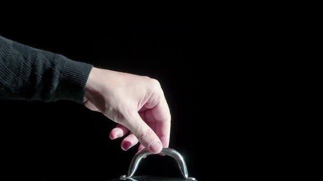 Lifting the Lids from the Pans. White Clouds of steam rise from under the raised cap on a black background