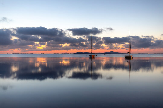 View of the Mar Menor at dawn with two boats on its waters, Punta Prima, Cartagena, Region of Murcia, Spain