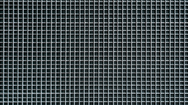 Close-up of galvanized steel security mesh fence, precise rectangular grid pattern, natural daylight, realistic zinc texture and welded joints, commercial infrastructure and
