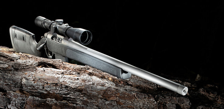 Bull barrel on a bolt action rifle resting on a log