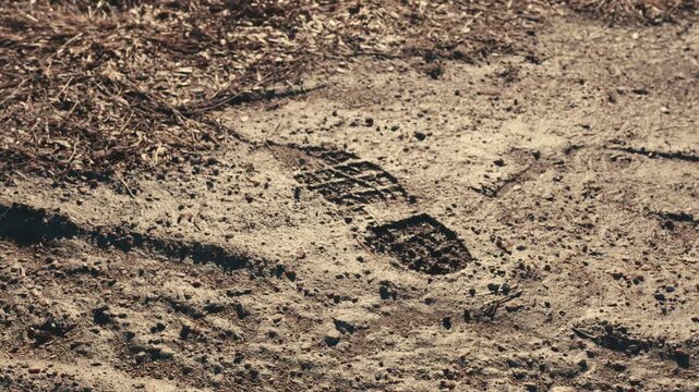 Boot footprint impression on a dusty trail