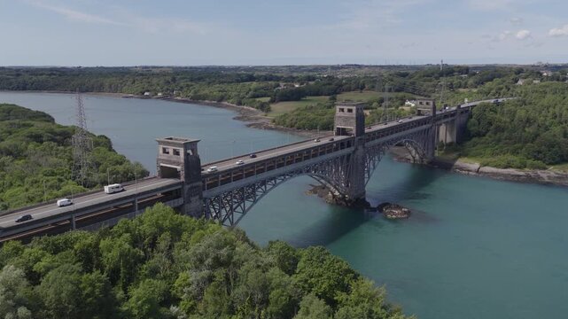 Establishing aerial view of the Britannia Bridge that crosses the Menai Strait between the Isle of Anglesey and mainland Wales, United Kingdom