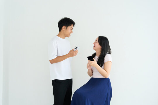 Japanese Man and Woman Using Smartphones Together