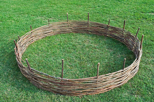 circular willow fence on green grass