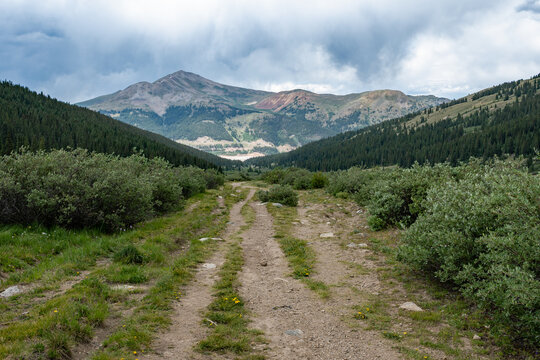 View of mountains from Mayflower Gulch Trail near Copper Mountain, Colorado under summer afternoon cloudscape.