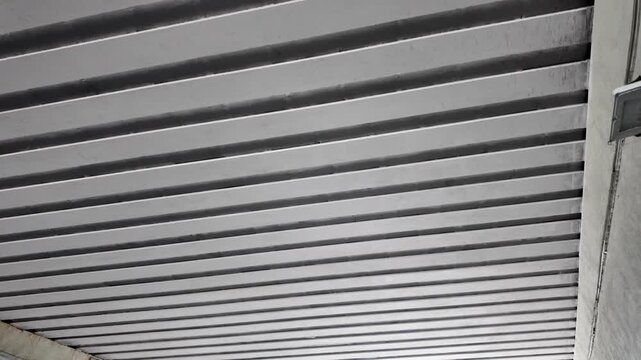 Aesthetic cinematic view of slat aluminum suspended ceiling in modern tunnel
