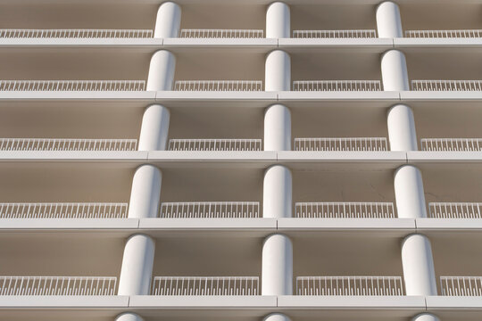 Curved balconies repeat in symmetry through a close study of architecture, while the urban facade lets repetition shape geometry into a pattern across the building.