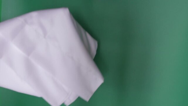 Male hand waving a white flag for surrender