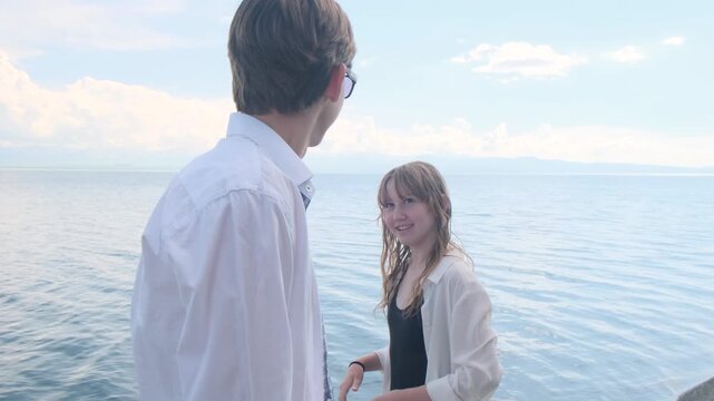 Young brother and sister playfully teasing each other on the seashore, joking and playing harmless pranks, teenage games and behavior, sibling interaction, teenage psychology