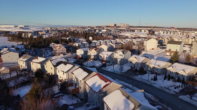 Experience the enchanting winter scenery of Beachville, Halifax, where quaint, snow-covered homes gleam beautifully in the warm glow of the golden hour