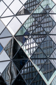 Angular panes break an urban building into triangles as mirror shifts, then glass reflection crosses the facade before windows frame architecture within fractured geometry.