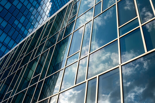 Angled edges cross an urban building as the diagonal facade meets bright clouds, then sky reflection settles on glass before windows organize architecture into geometry.