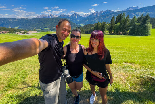 Holiday, mountain and portrait of family with smile, nature and outdoor bonding together on travel adventure. Mom, dad and child on summer vacation with hiking, happy face and sunshine on hill