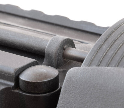 Clip on an AR rifle that holds the dust cover on
